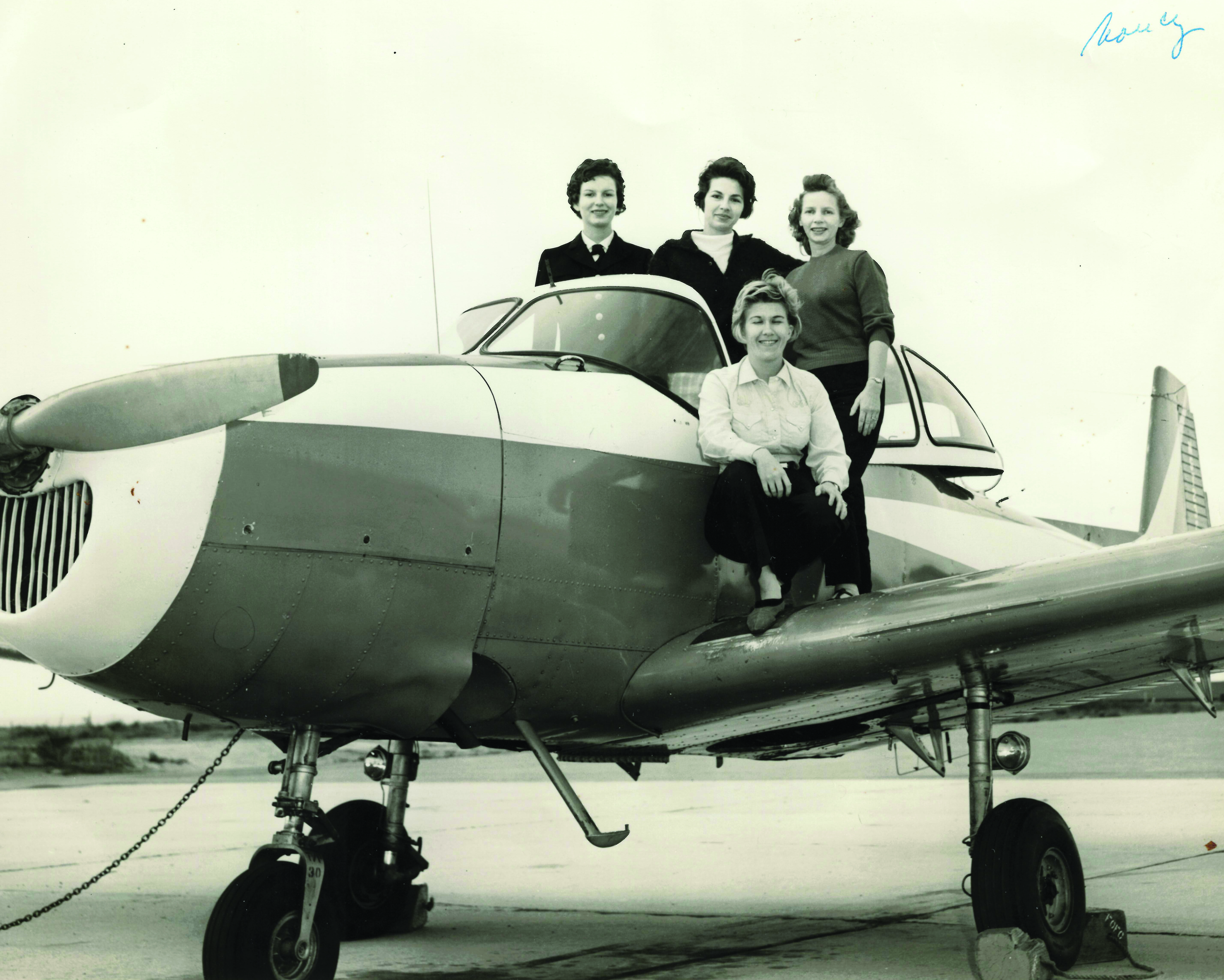 When Nancy Hunter was in her first assignment
        at the Navy Postgraduate School in Monterey, she
        obtained her private pilot’s license; in this flying
        club photograph, she is standing at the far left.
        (Photo courtesy of author)